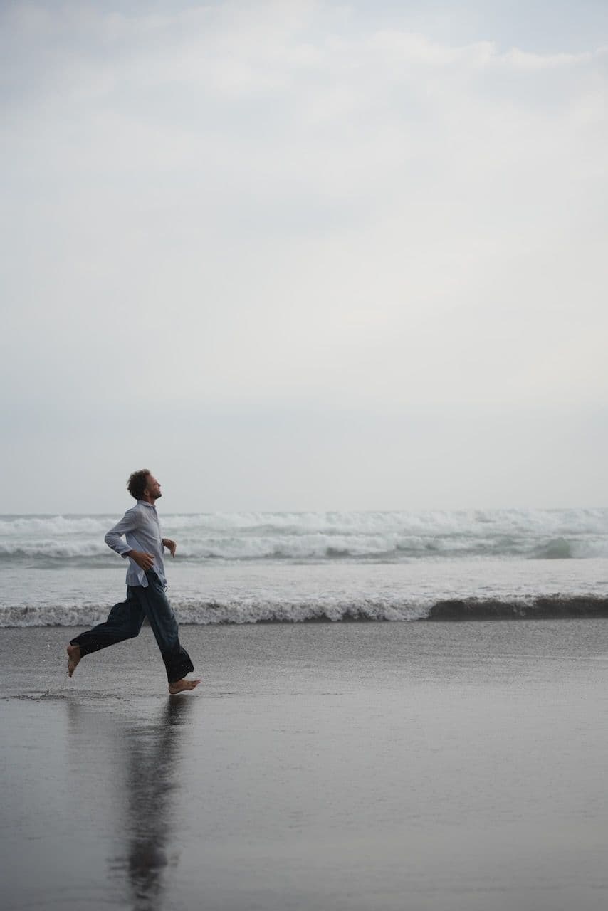 Miki running along the shore