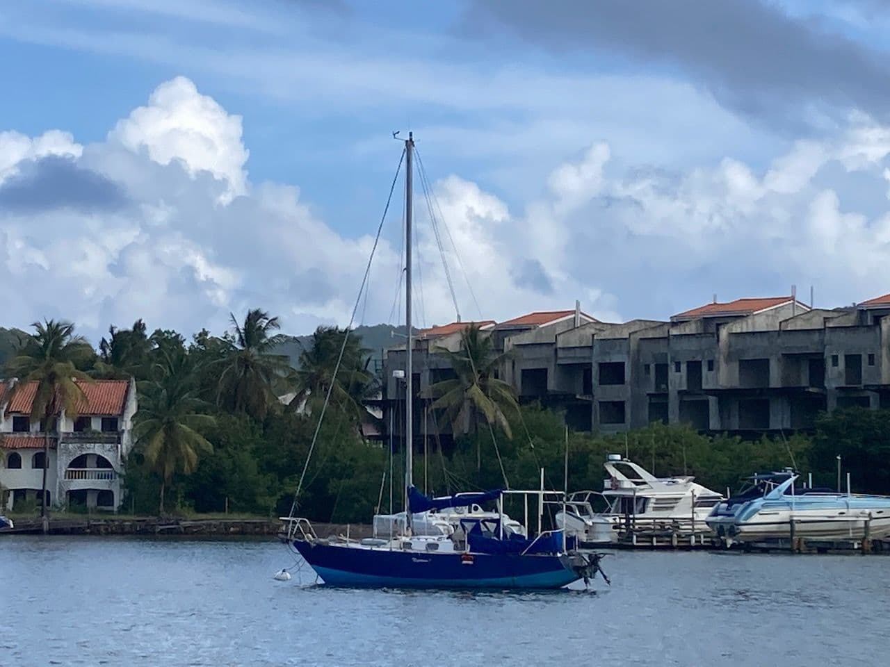 Miki's blue sailboat at anchor in the Caribbean