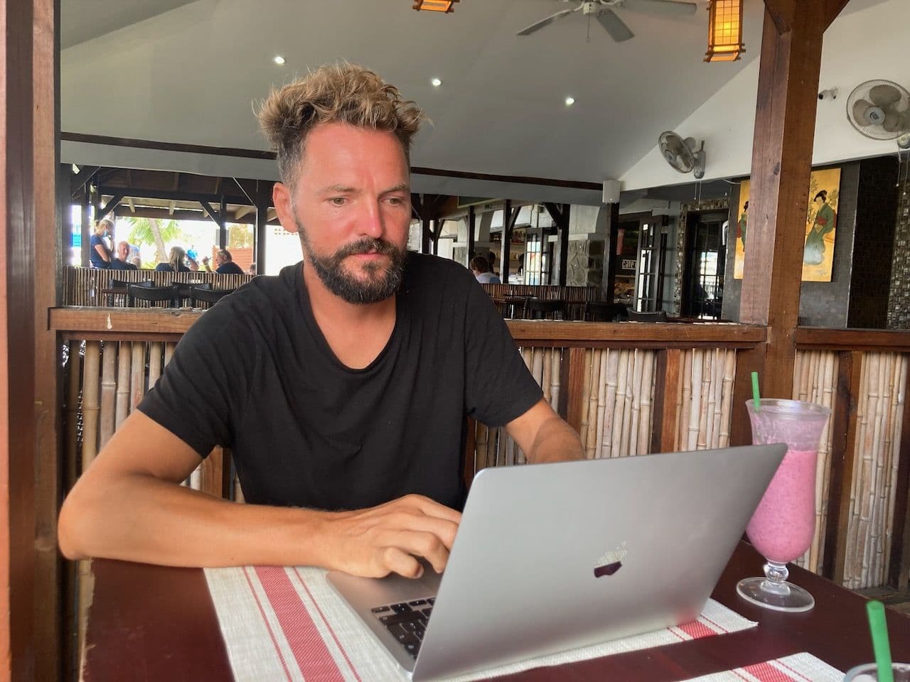 Working on a laptop in a Caribbean beach bar